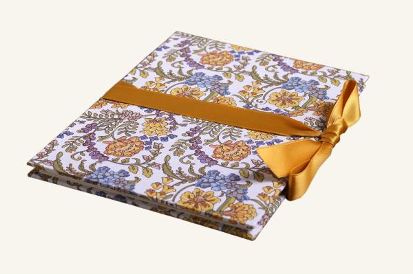 Mini photo album with mustard yellow and soft blue flowers, mustard yellow ribbon